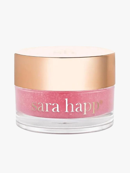 Sara Happ The Lip Scrub clear jar of pink lip scrub with gold lid on light gray background